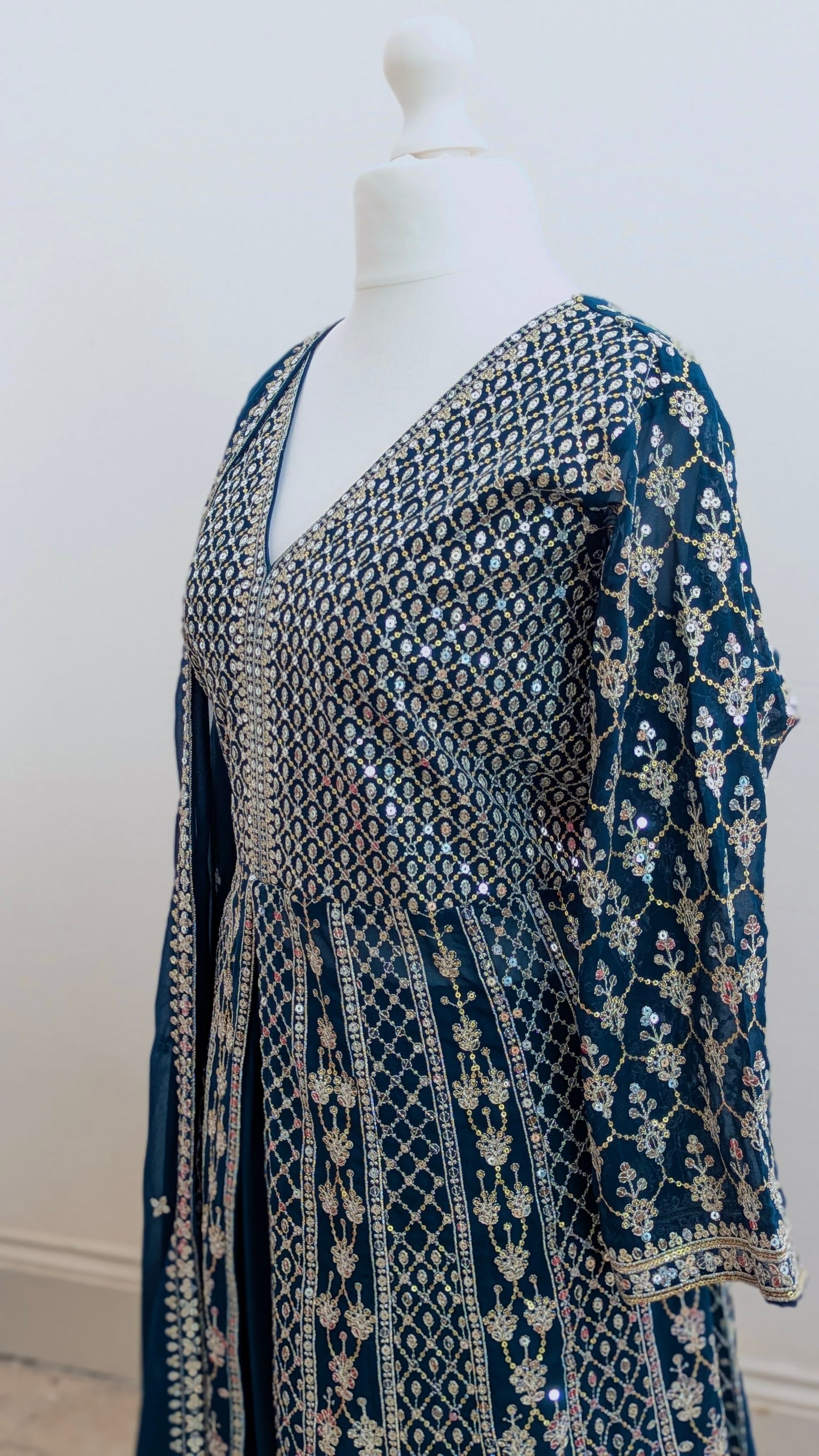 Mannequin in a teal Sherni London palazzo jacket set with front split all over silver embroidery and a dupatta