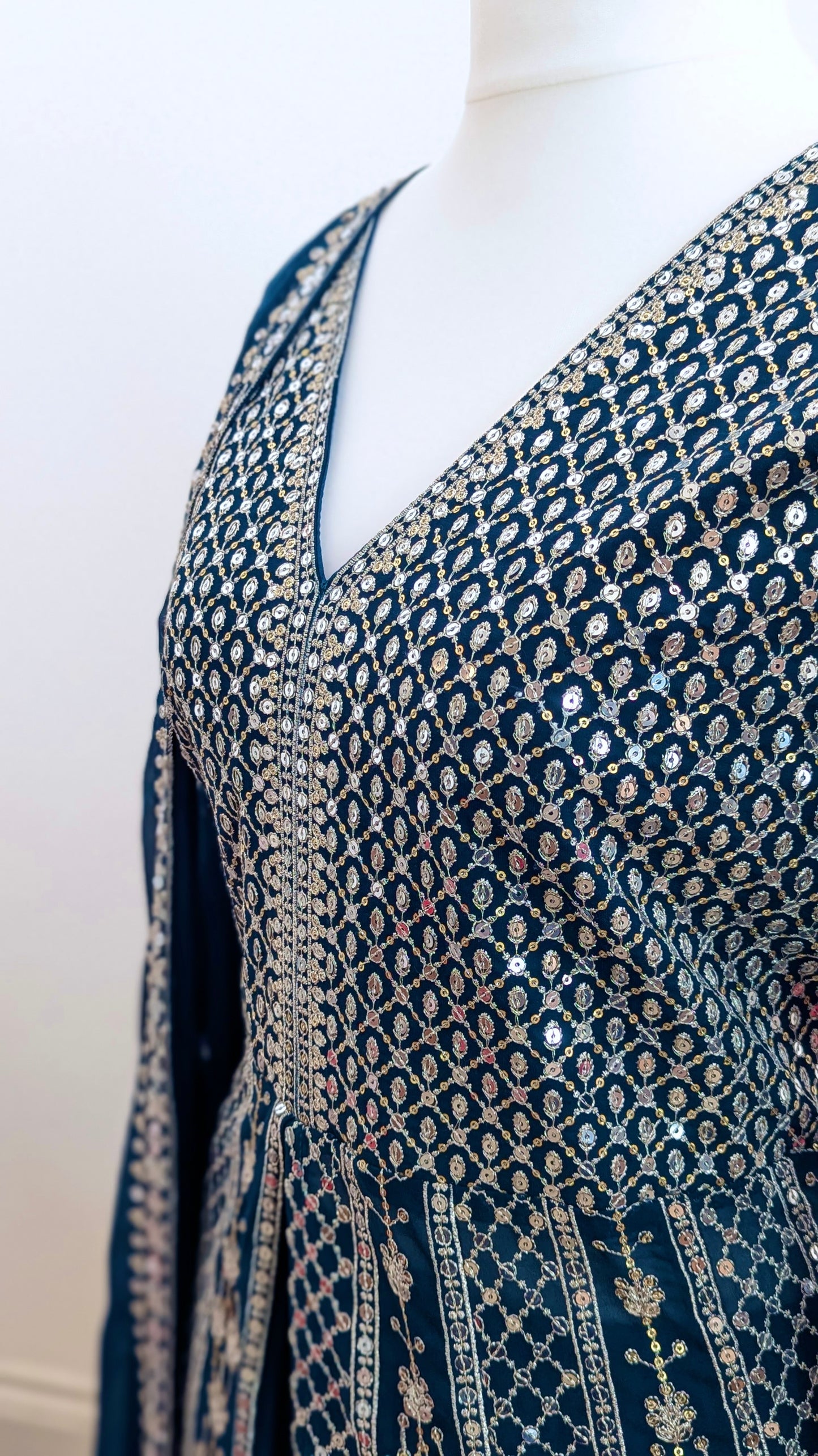 Mannequin in a teal Sherni London palazzo jacket set with front split all over silver embroidery and a dupatta