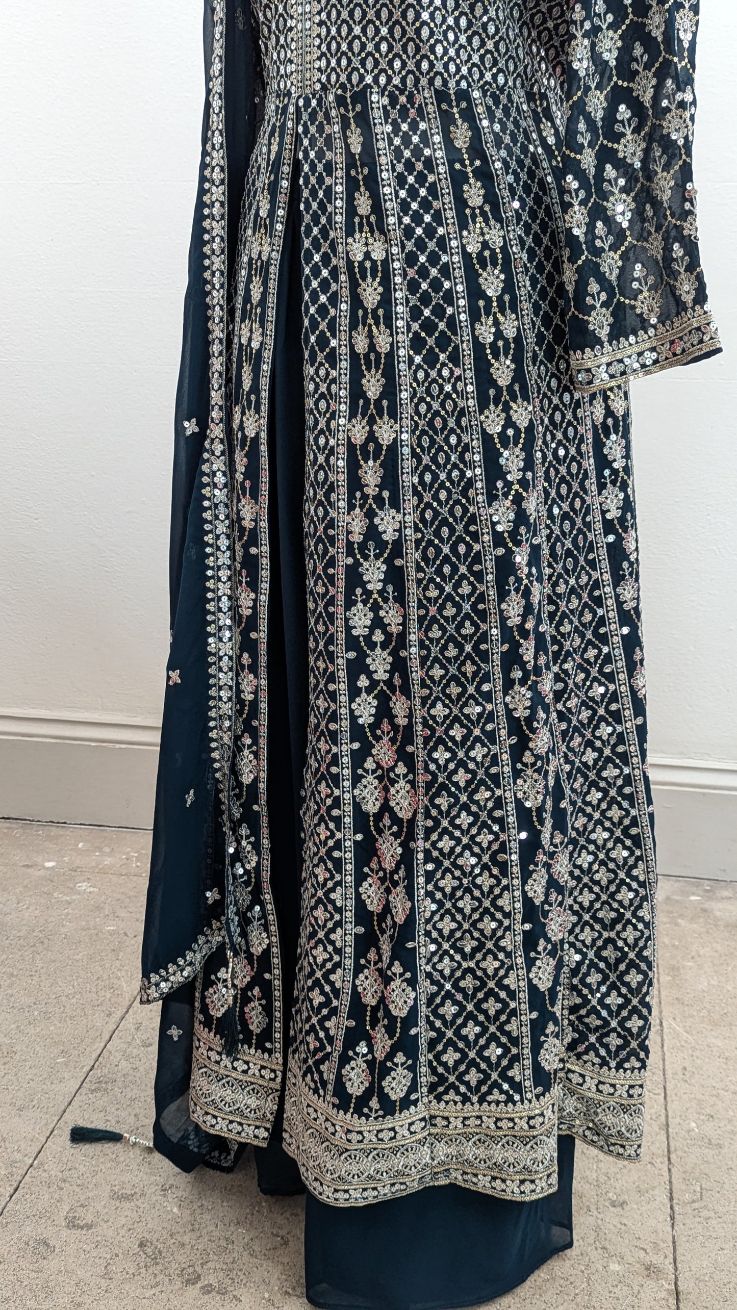 Mannequin in a teal Sherni London palazzo jacket set with front split all over silver embroidery and a dupatta