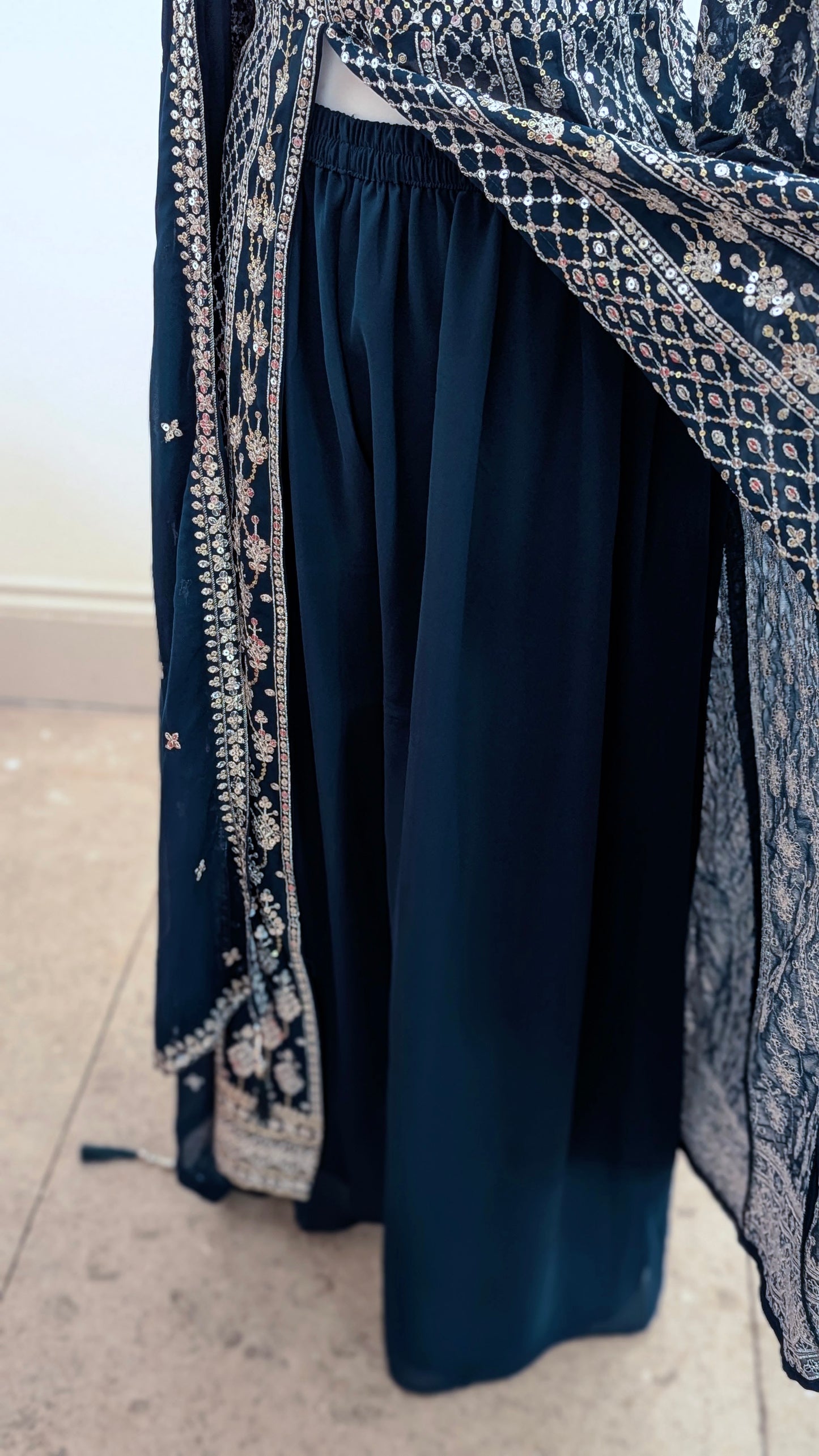 Mannequin in a teal Sherni London palazzo jacket set with front split all over silver embroidery and a dupatta