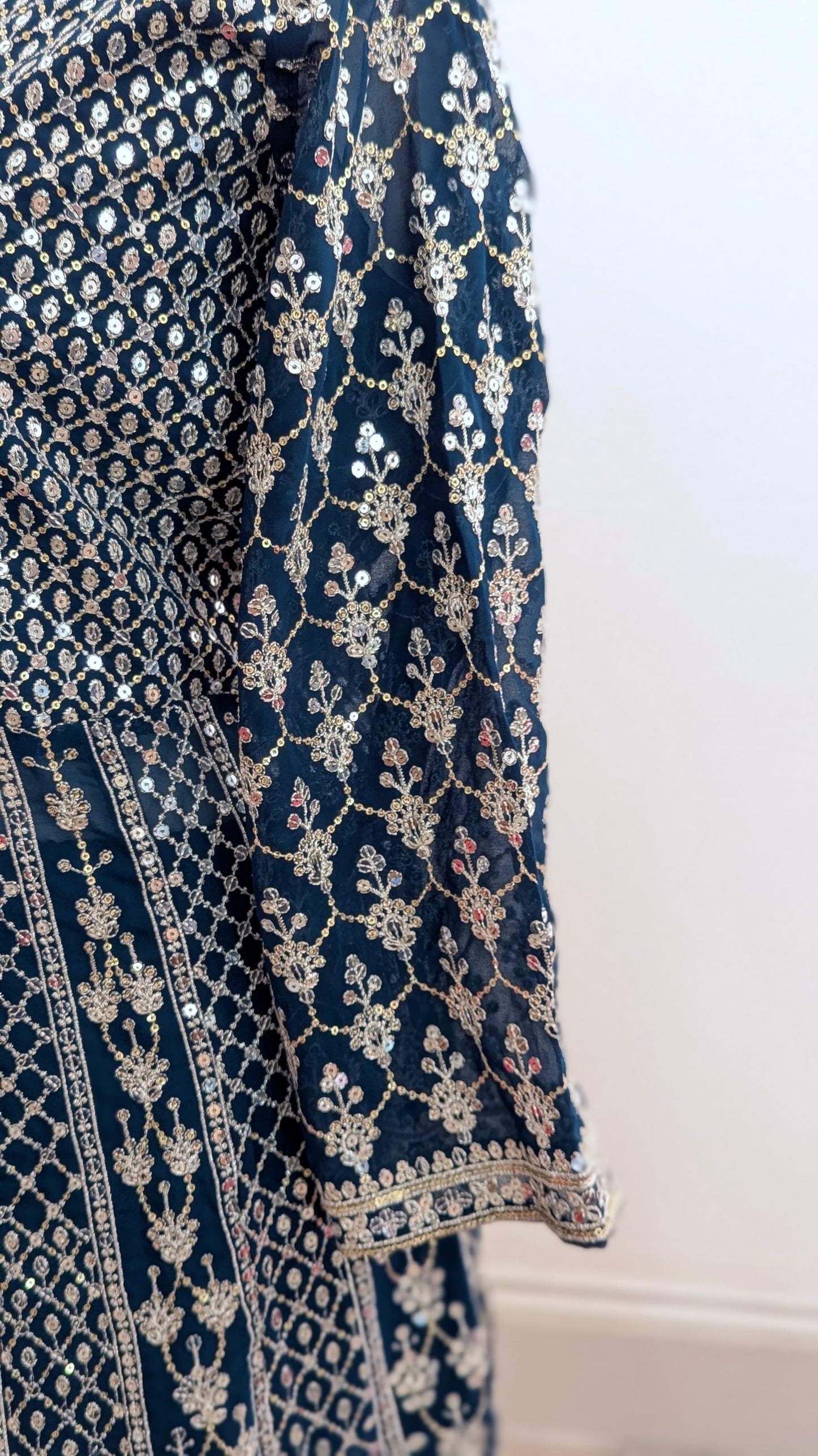 Mannequin in a teal Sherni London palazzo jacket set with front split all over silver embroidery and a dupatta