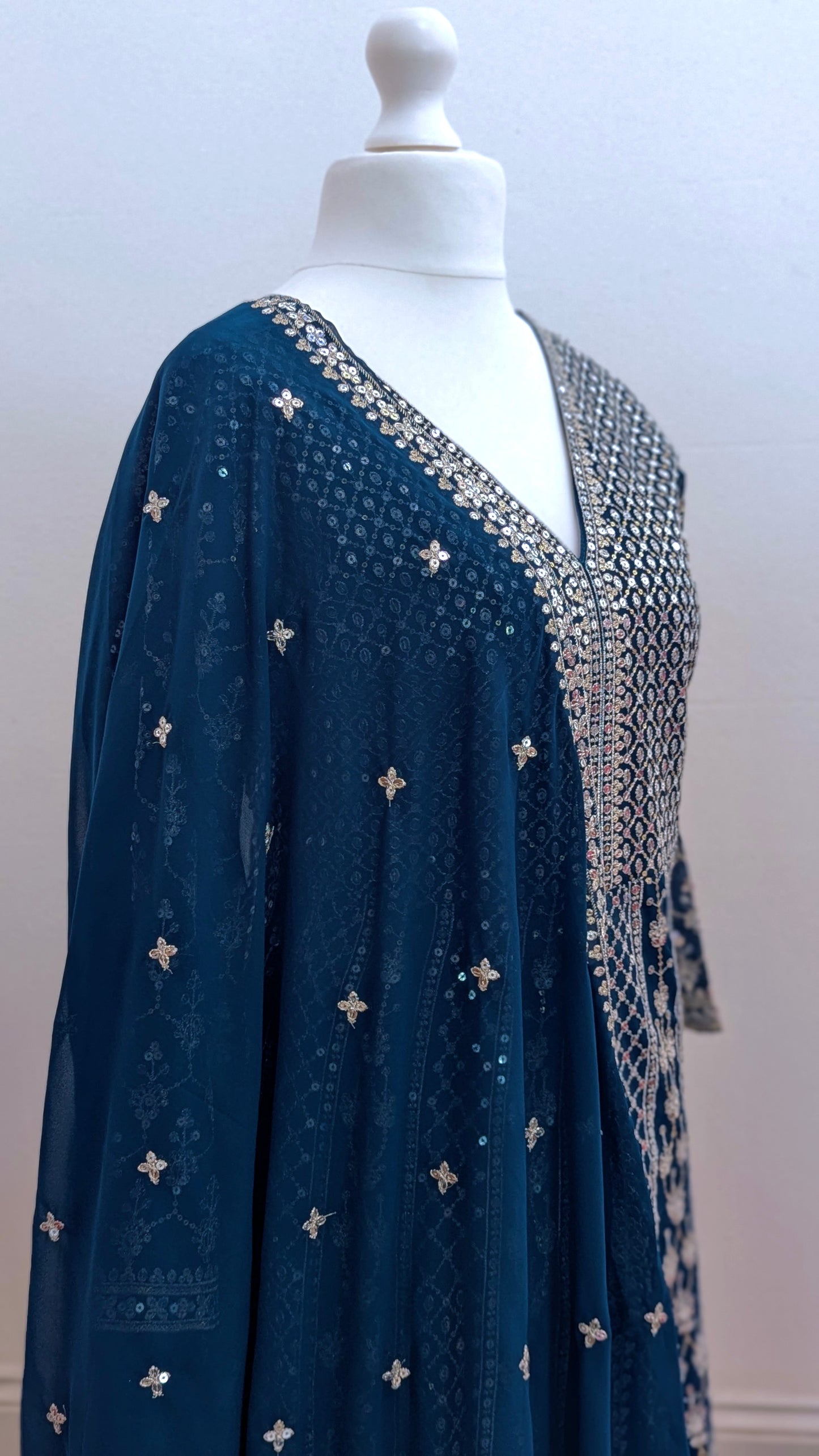 Mannequin in a teal Sherni London palazzo jacket set with front split all over silver embroidery and a dupatta