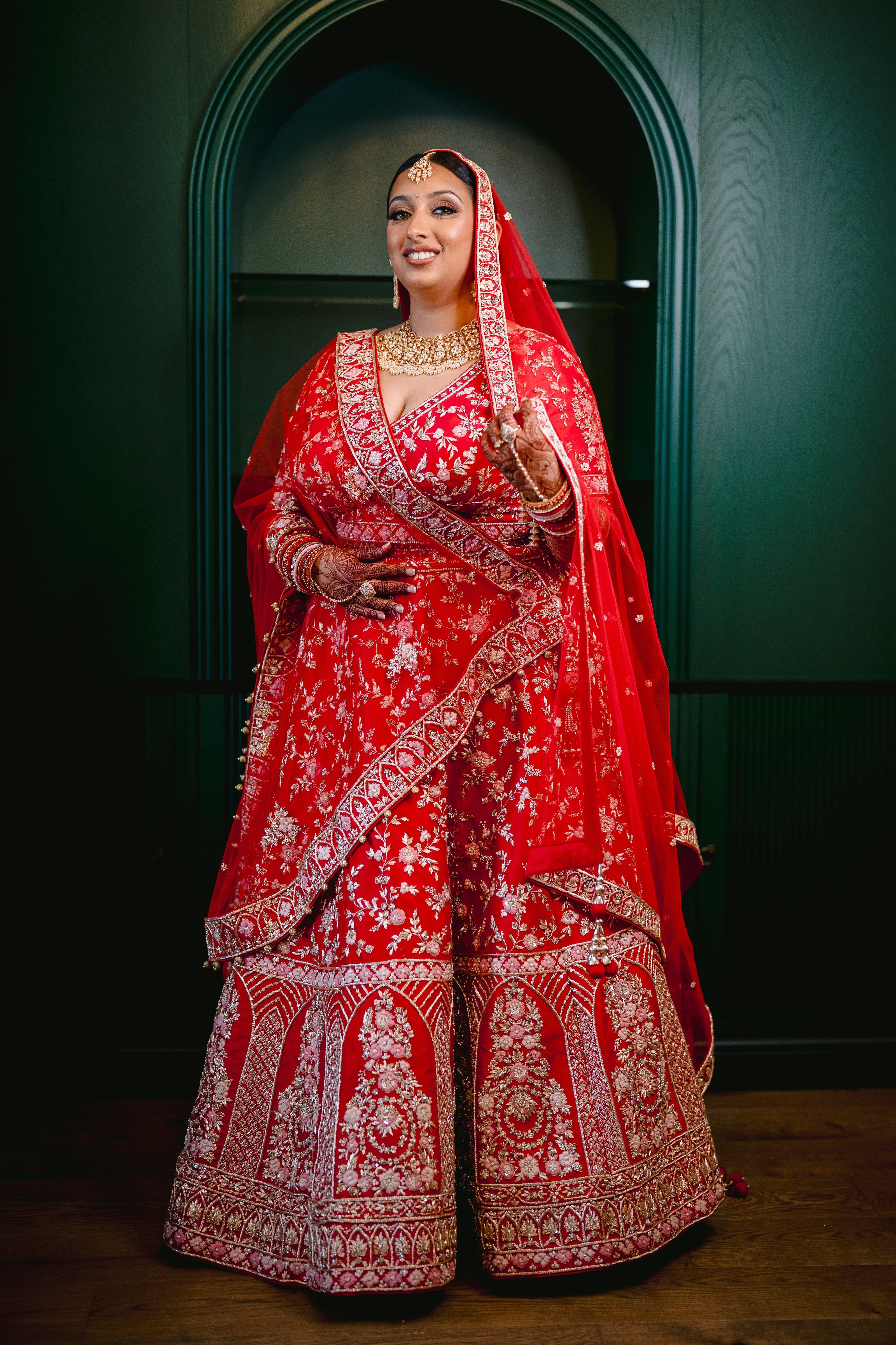 Sherni London real Indian bride in red lehenga and two dupattas, gold embroidery and multicoloured threadwork
