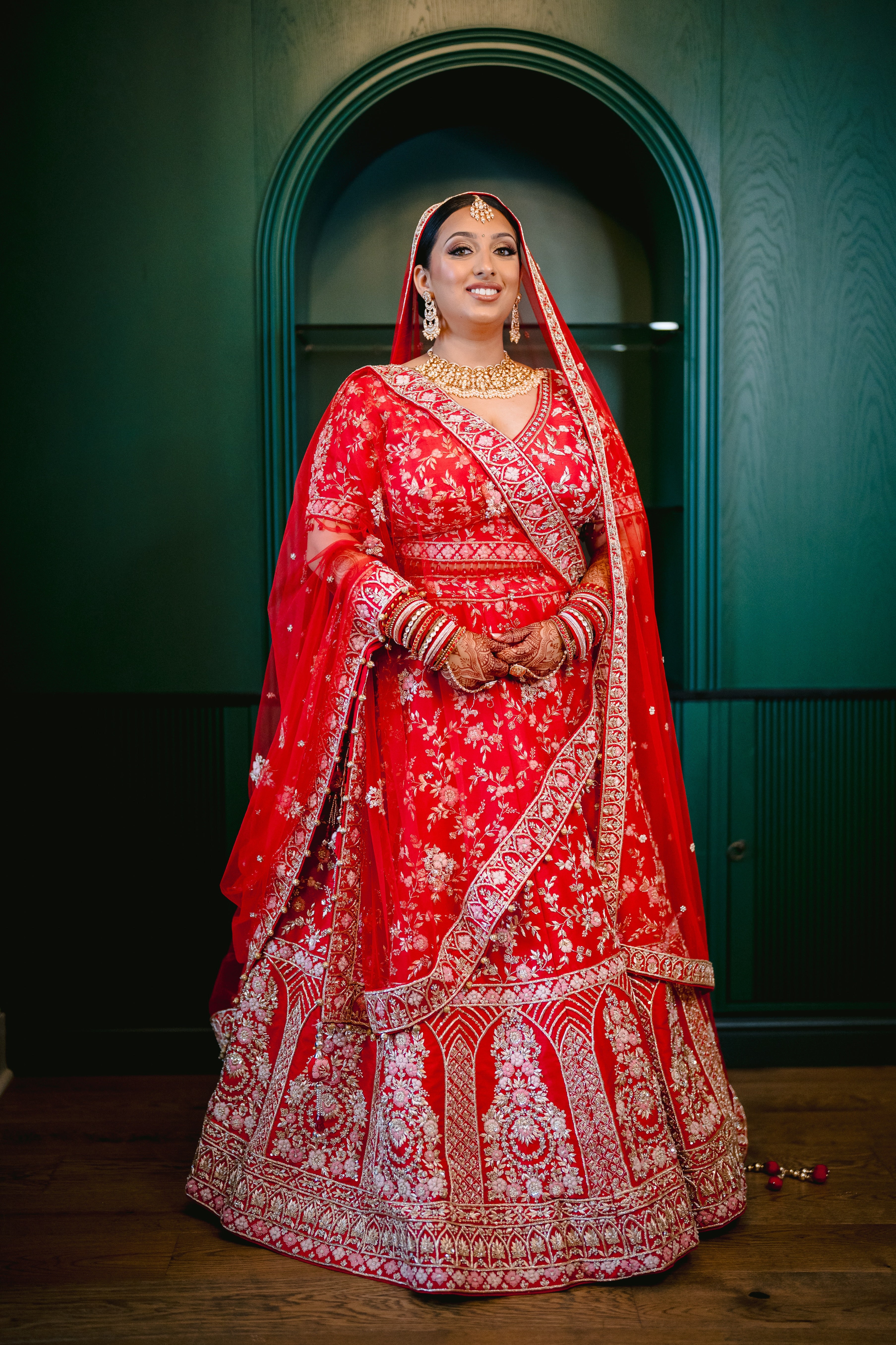 Sherni London bride Hiral in red Indian bridal lehenga two dupattas gold hand embroidery custom bespoke bridal outfit