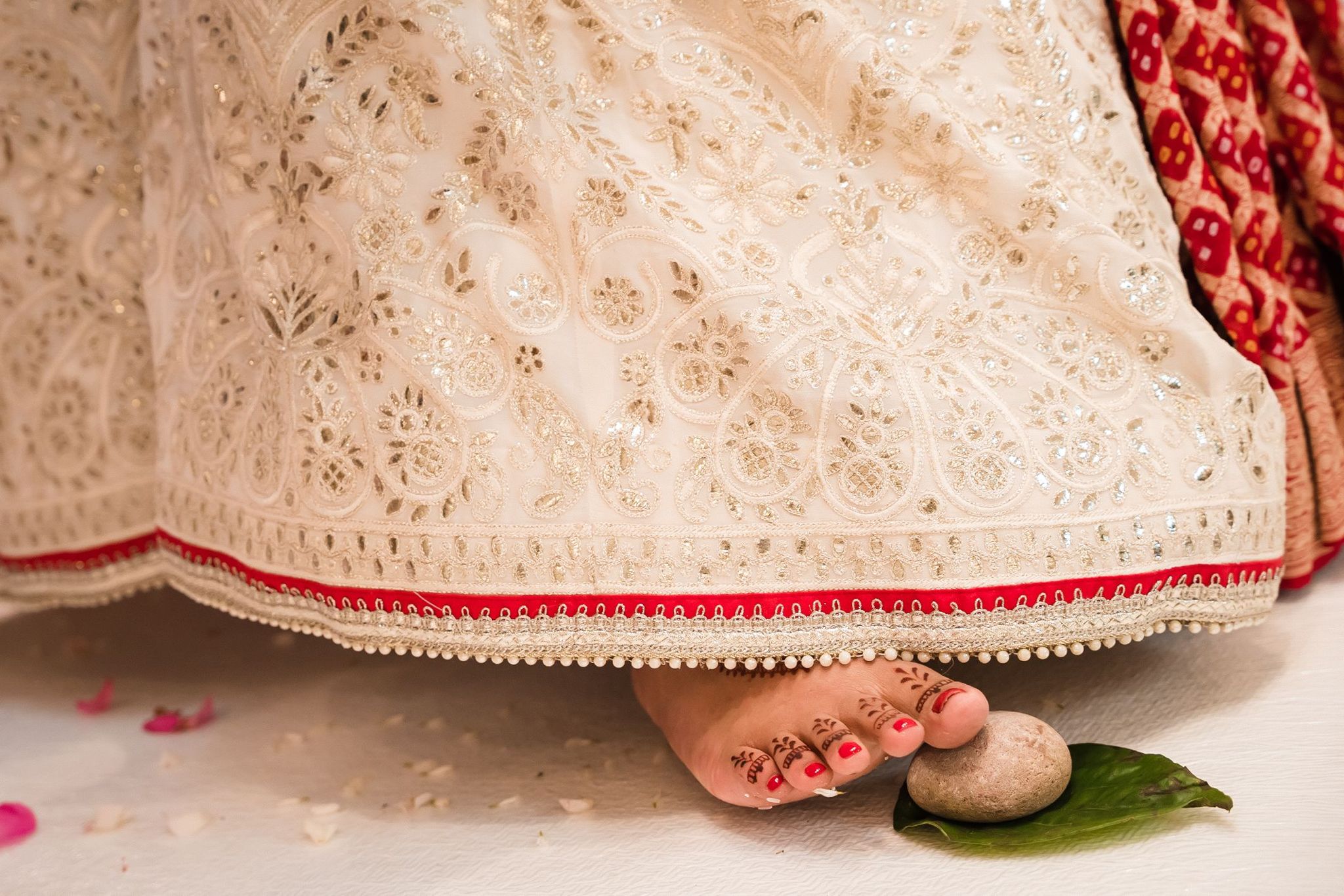 Sherni London cream bridal chikankari lucknowi lehenga with gota pati work close up with red border