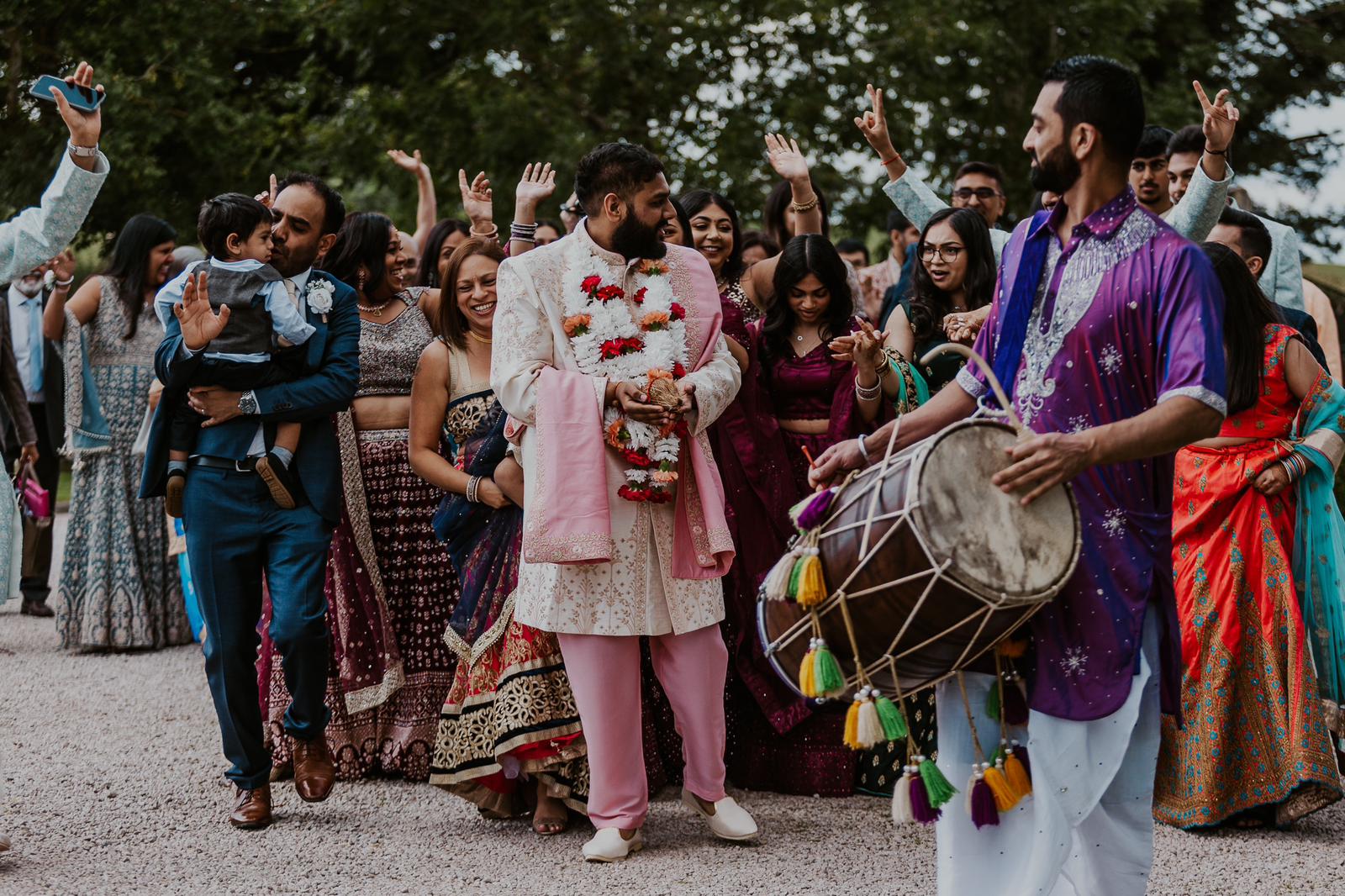 Sherni London groom in cream Indian sherwani with pink trousers and dupatta