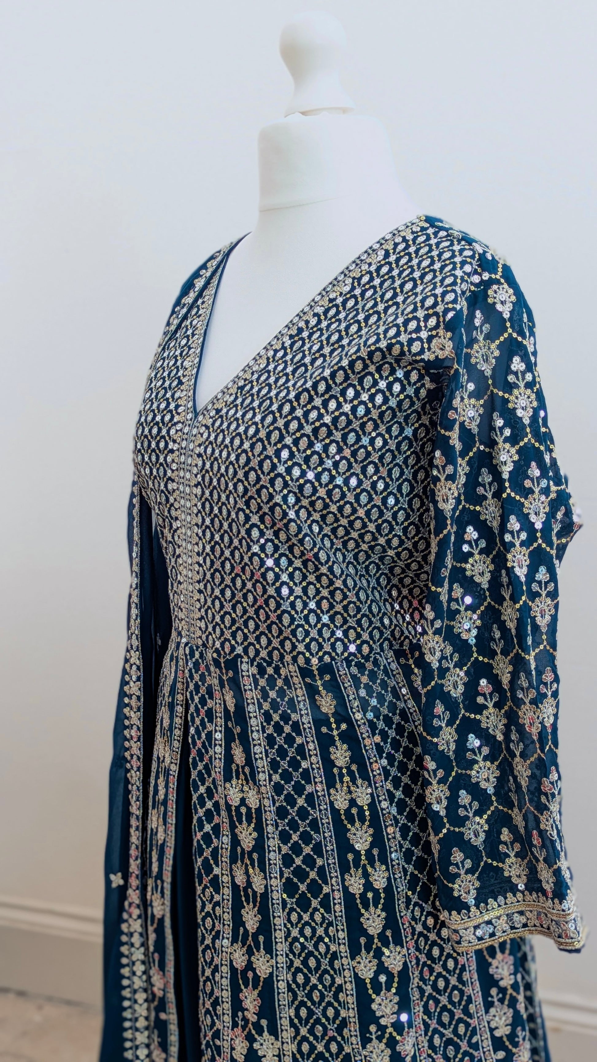 Mannequin in a teal Sherni London palazzo jacket set with front split all over silver embroidery and a dupatta