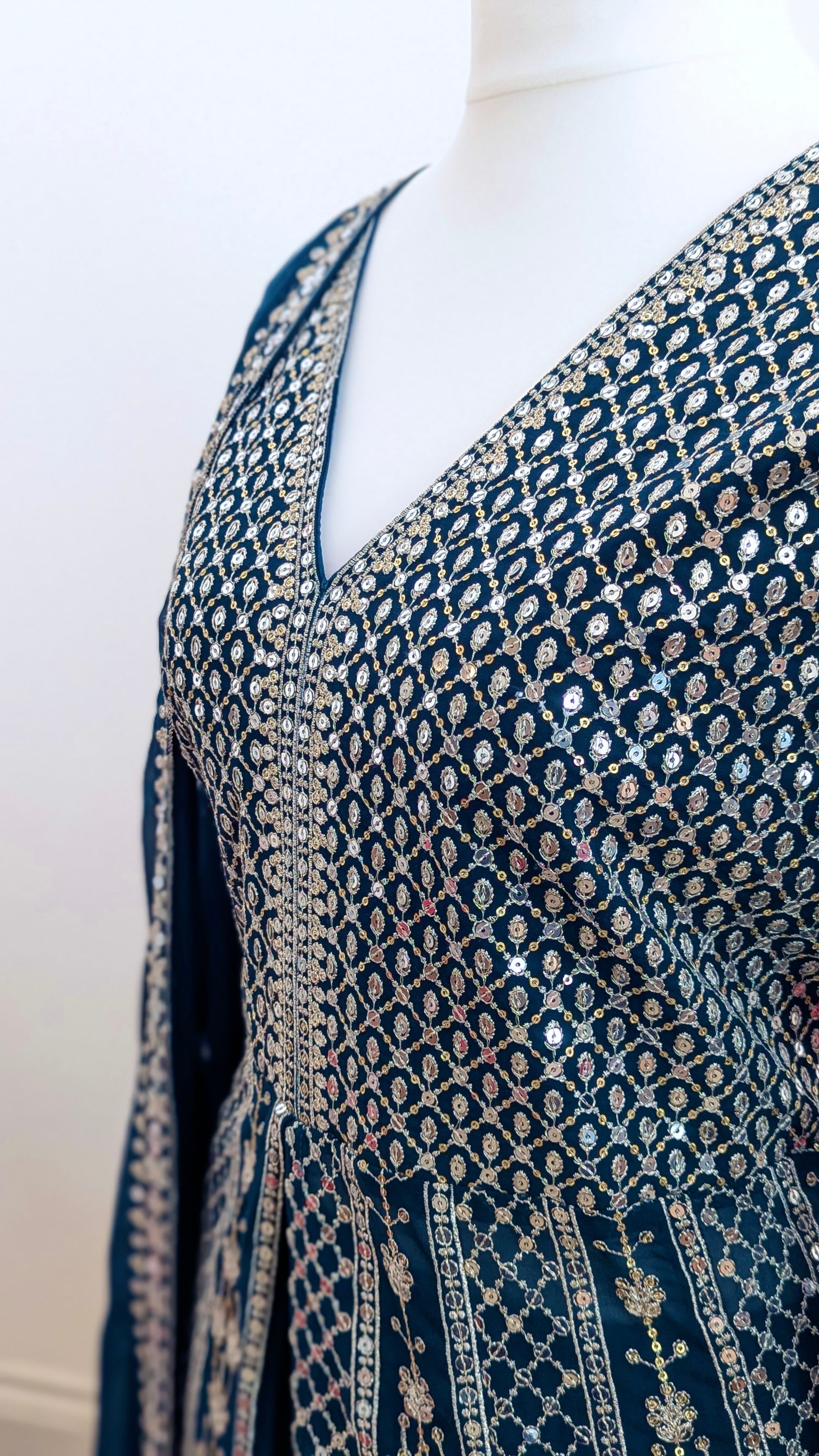 Mannequin in a teal Sherni London palazzo jacket set with front split all over silver embroidery and a dupatta