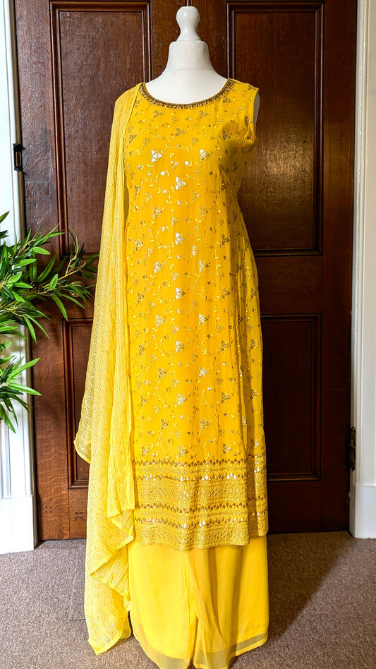 Yellow Punjabi palazzo suit with attachable sleeves and dupatta in georgette and tone on tone yellow floral embroidery with hand embroidery on neckline