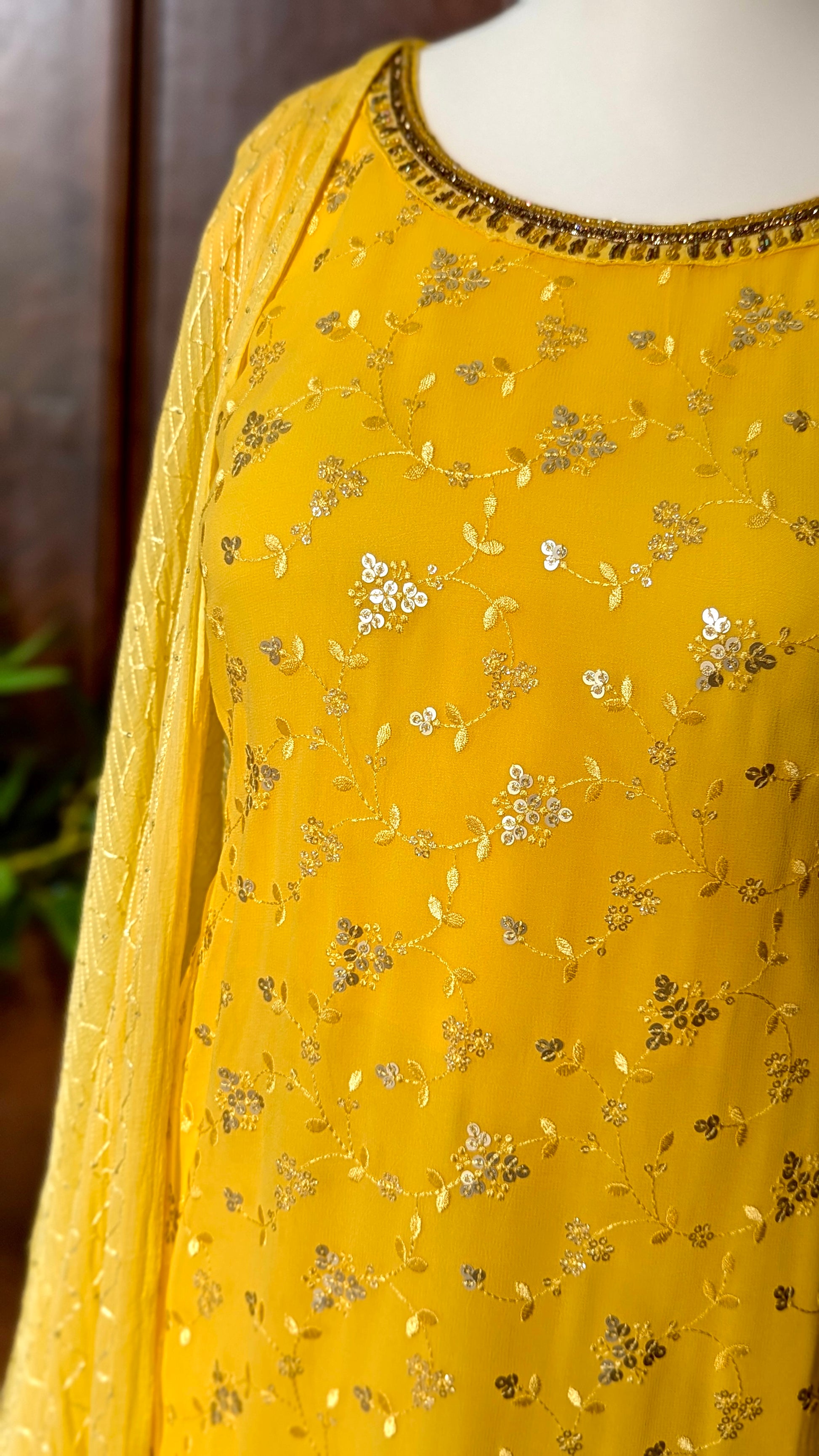 Yellow Punjabi palazzo suit with attachable sleeves and dupatta in georgette and tone on tone yellow floral embroidery with hand embroidery on neckline