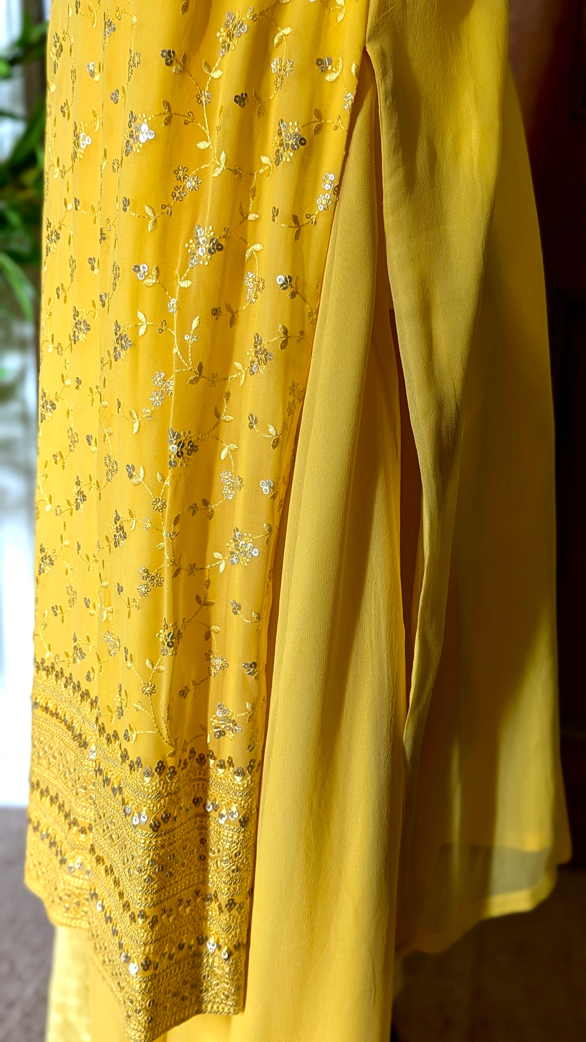 Yellow Punjabi palazzo suit with attachable sleeves and dupatta in georgette and tone on tone yellow floral embroidery with hand embroidery on neckline