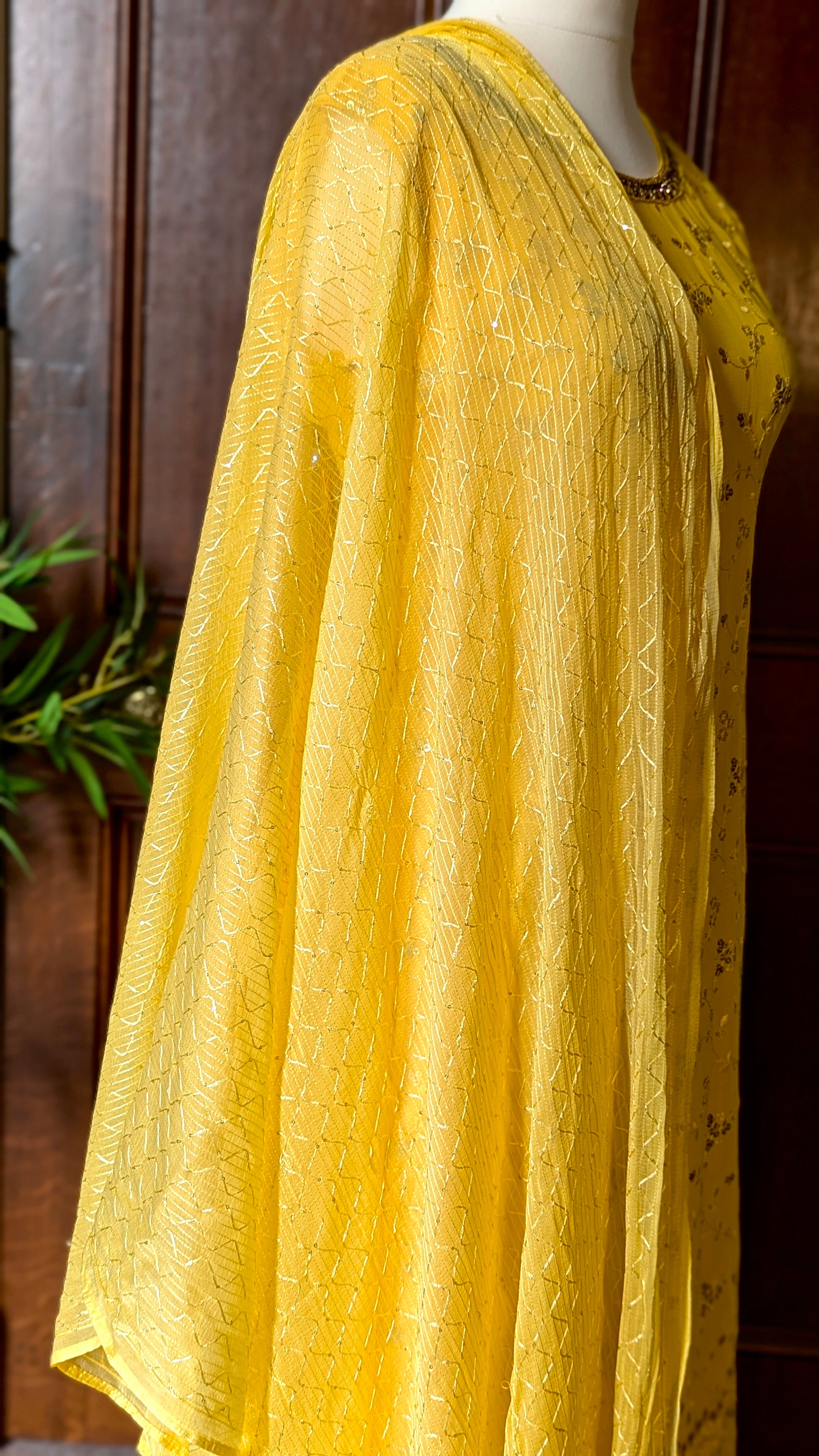 Yellow Punjabi palazzo suit with attachable sleeves and dupatta in georgette and tone on tone yellow floral embroidery with hand embroidery on neckline