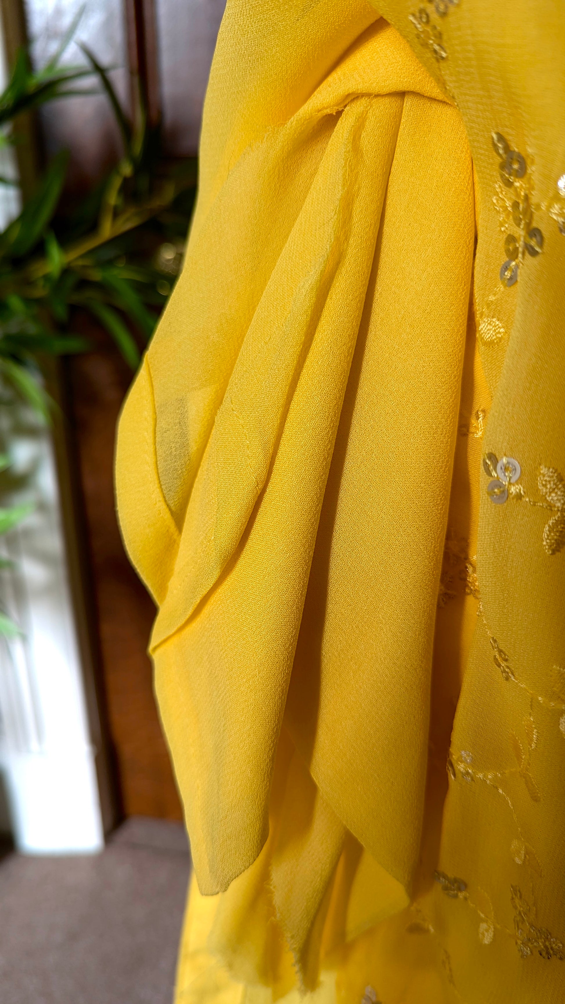 Yellow Punjabi palazzo suit with attachable sleeves and dupatta in georgette and tone on tone yellow floral embroidery with hand embroidery on neckline