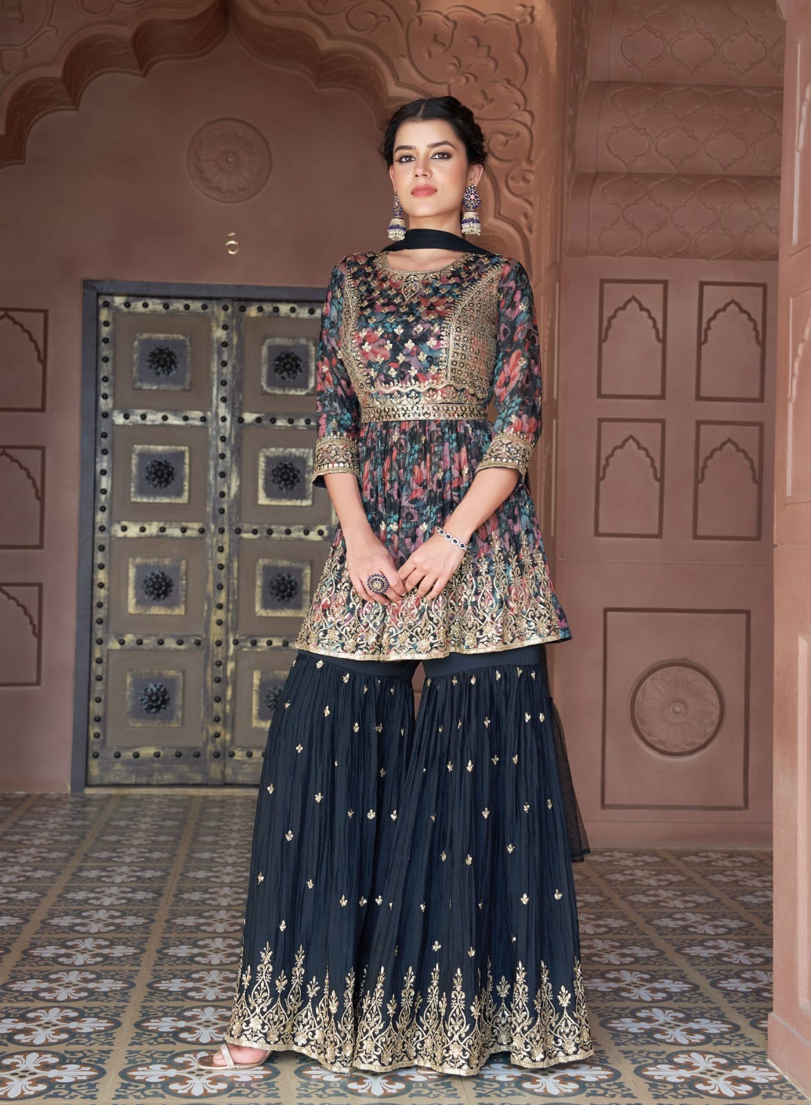 Sherni London plus size peplum gharara set in georgette chiffon with light gold embroidery on floral print. Long sleeves with narrow dupatta